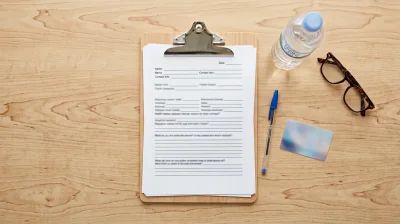 Patient completing paperwork before a medical visit